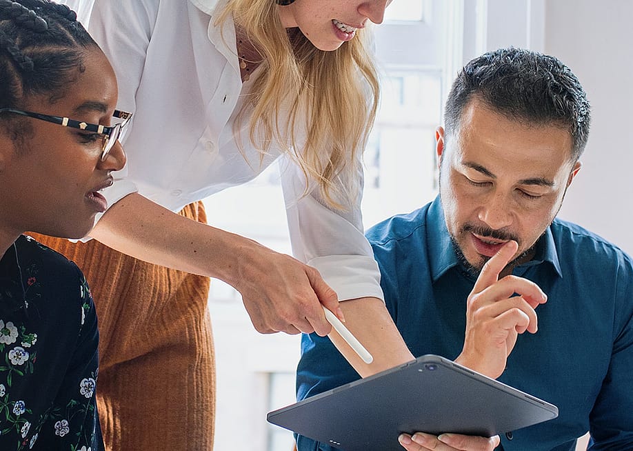 A team of colleagues collaborating for a work project in an office. — Rawpixel.com // Shutterstock