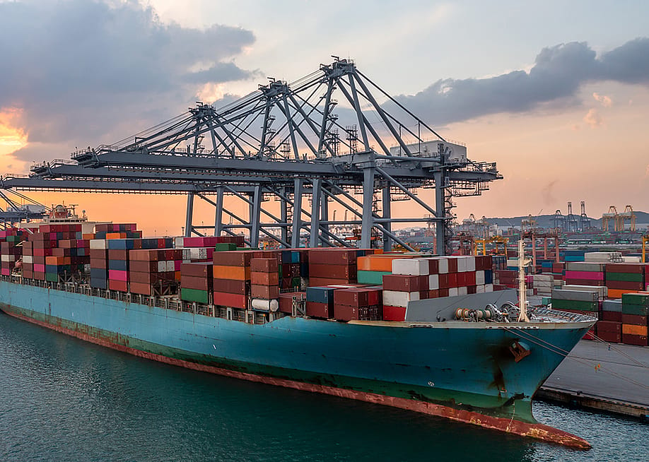 A commercial cargo ship at a terminal seaport. — Darunrat Wongsuvan // Shutterstock