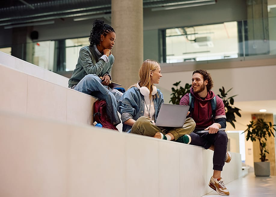 A diverse group of university students having a discussion in campus. — Drazen Zigic // Shutterstoc
