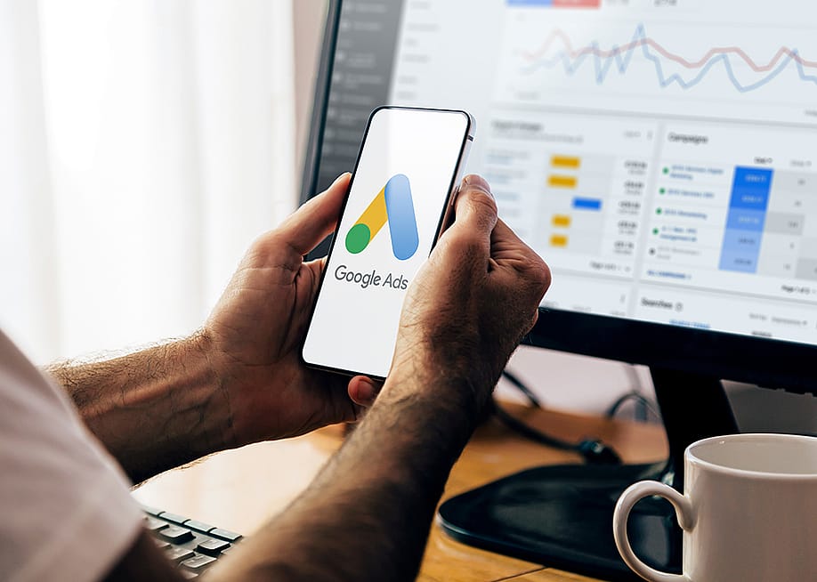 Man using a mobile phone with Google Ads on the screen. — Alex Photo Stock // Shutterstock