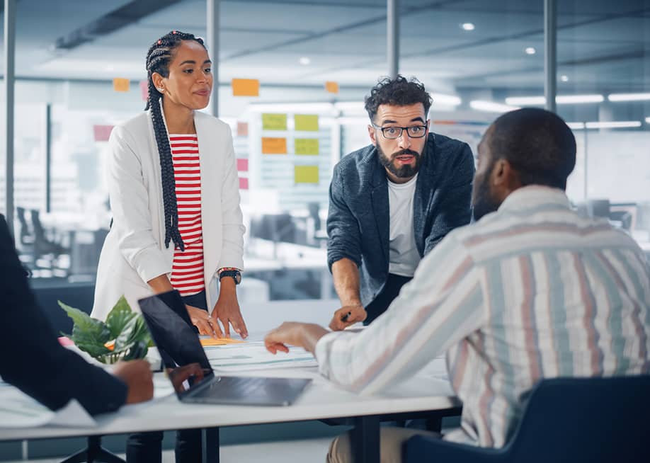A diverse business group having a meeting in a modern office. — Gorodenkoff // Shutterstock