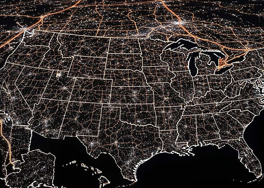 A view of the United States of America at night, highlighted by city lights. — YUBISAN // Shutterstock