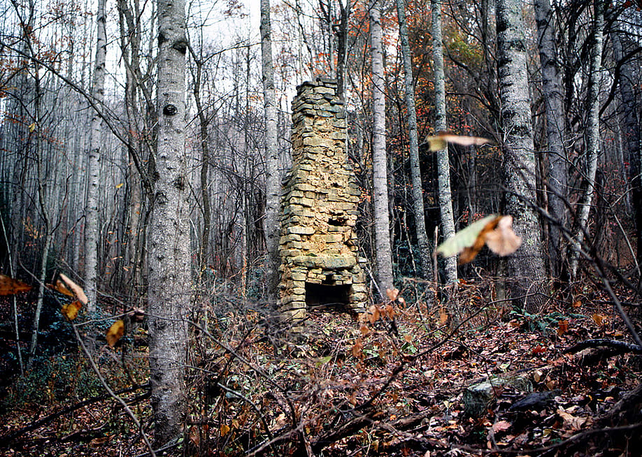 A stone chimney is seen from a 19th century log cabin located in the Appalachian Mountains in Northern America. — Robert Alexander // Archive Photos / Getty Images