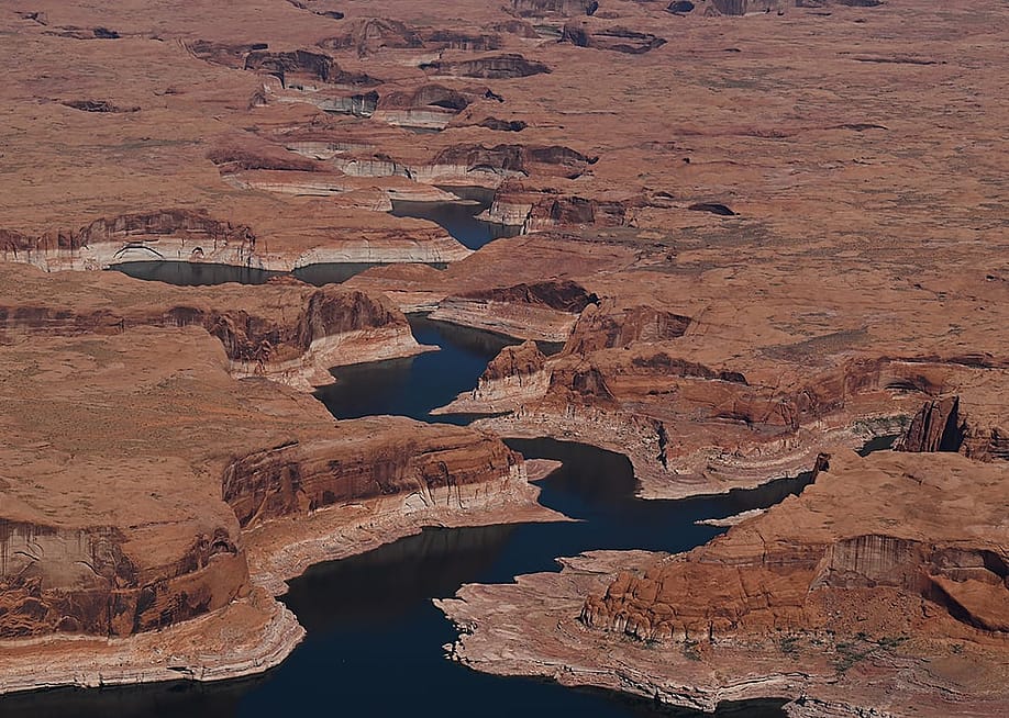 A bathtub ring marks the receded shoreline at Lake Powell, where water levels remain low in Glen Canyon National Recreation Area on April 30, 2026, near Big Water, Utah. — RJ Sangosti // MediaNews Group / The Denver Post via Getty Images