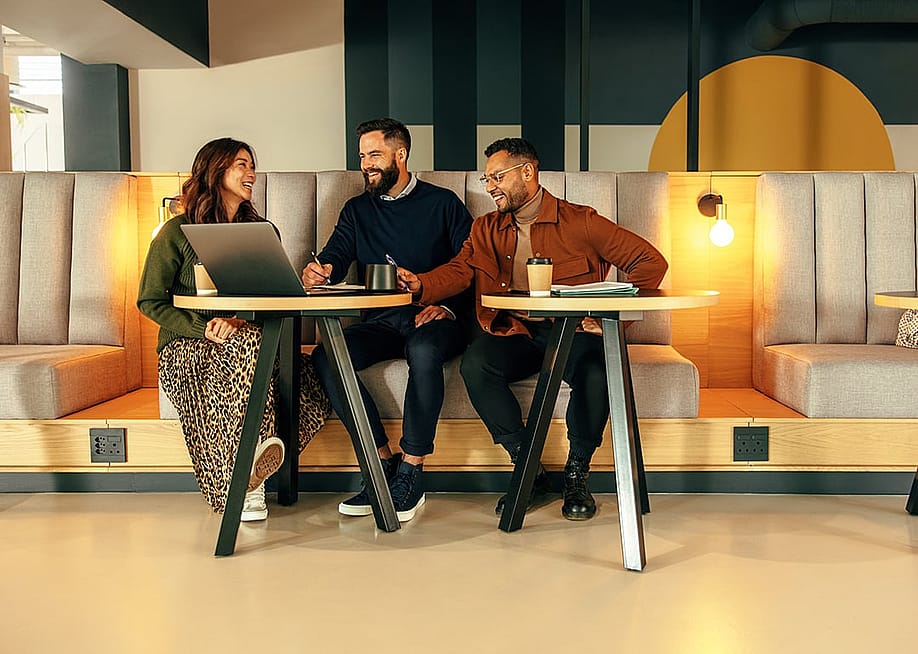 A group of young entrepreneurs working together in a lobby. — Jacob Lund // Shutterstock