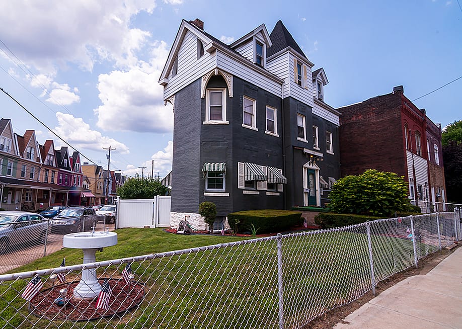 A three-story house built in 1929 and seen along Dawson Street in the south Oakland neighborhood in Pittsburgh, Pennsylvania, USA. — woodsnorthphoto // Shutterstock