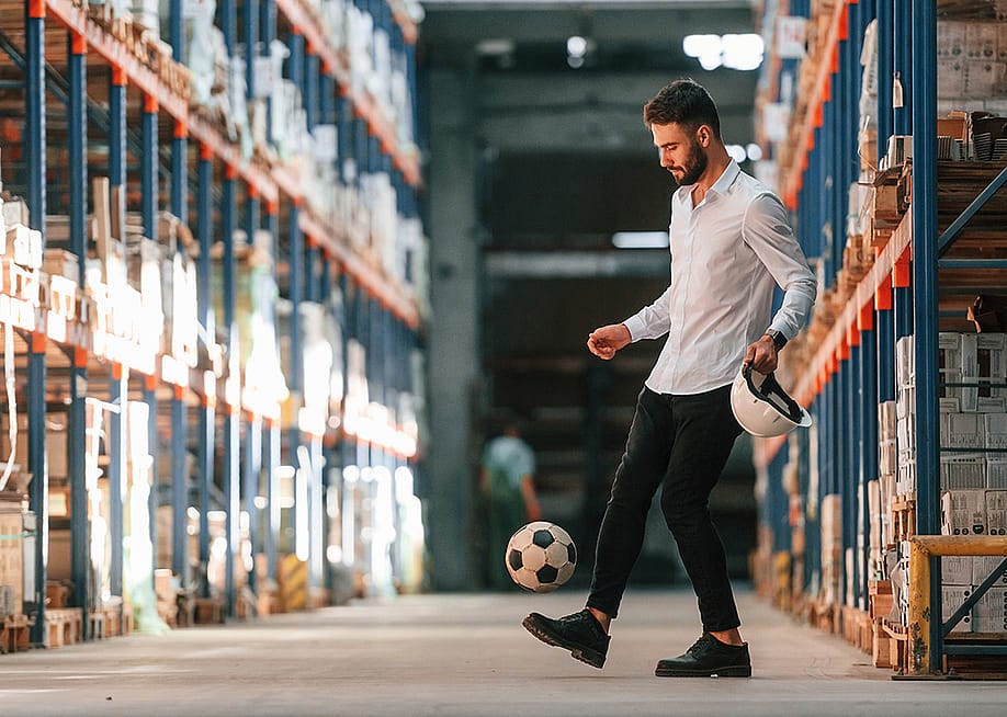 A storage working kicking a soccer ball. — Standret // Shutterstock