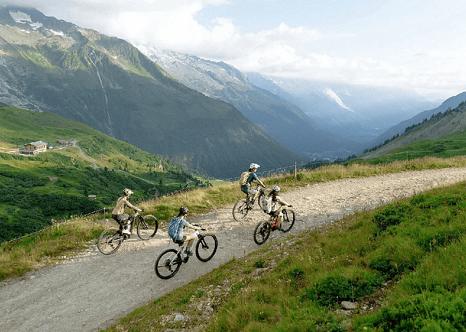 A group of e-mountain bikers riding through glacial mountains. — EF Adventures
