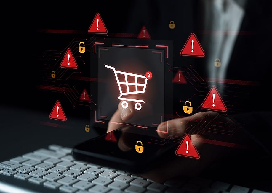 E-commerce security alert graphics over a person typing on a keyboard while shopping online. — Koupei Studio // Shutterstock