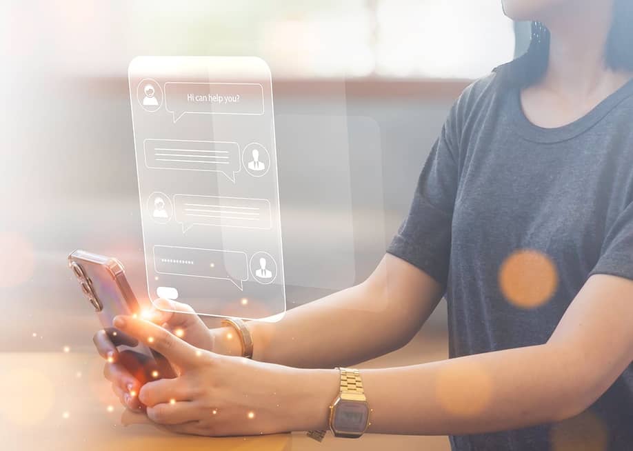 A young woman using a smartphone illustrated with AI chatbot conversations. — Pniti_Studio // Shutterstock