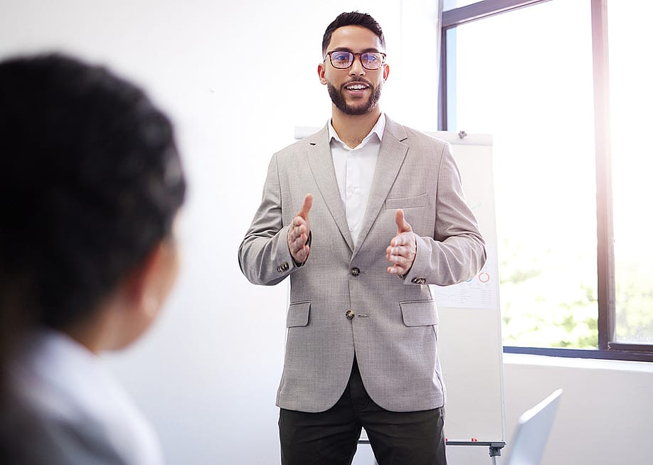 A business manager presenting a sales pitch sample during a workshop session. — PeopleImages // Shutterstock