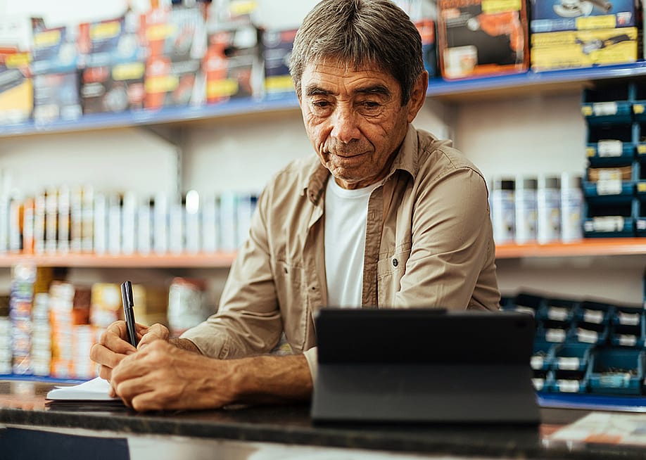 A business owner taking orders at his hardware shop. — Kleber Cordeiro // Shutterstock
