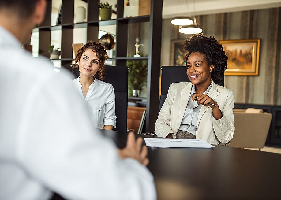 Business managers collaborating during a meeting with a prospective partner. — Branislav Nenin // Shutterstock