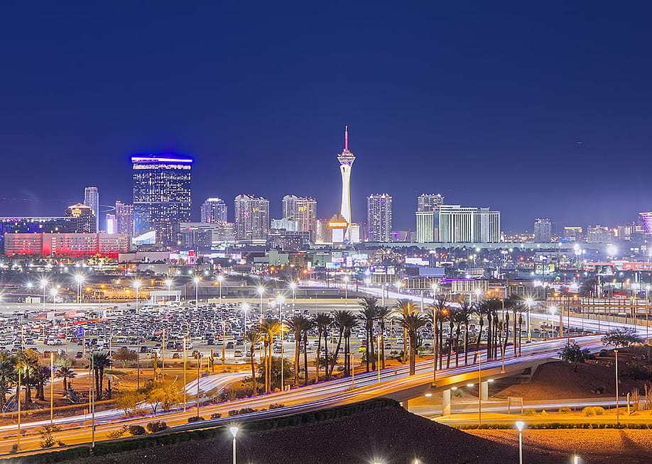 A view of the Las Vegas skyline as seen from Harry Reid Airport at night. — SnapASkyline // Shutterstock