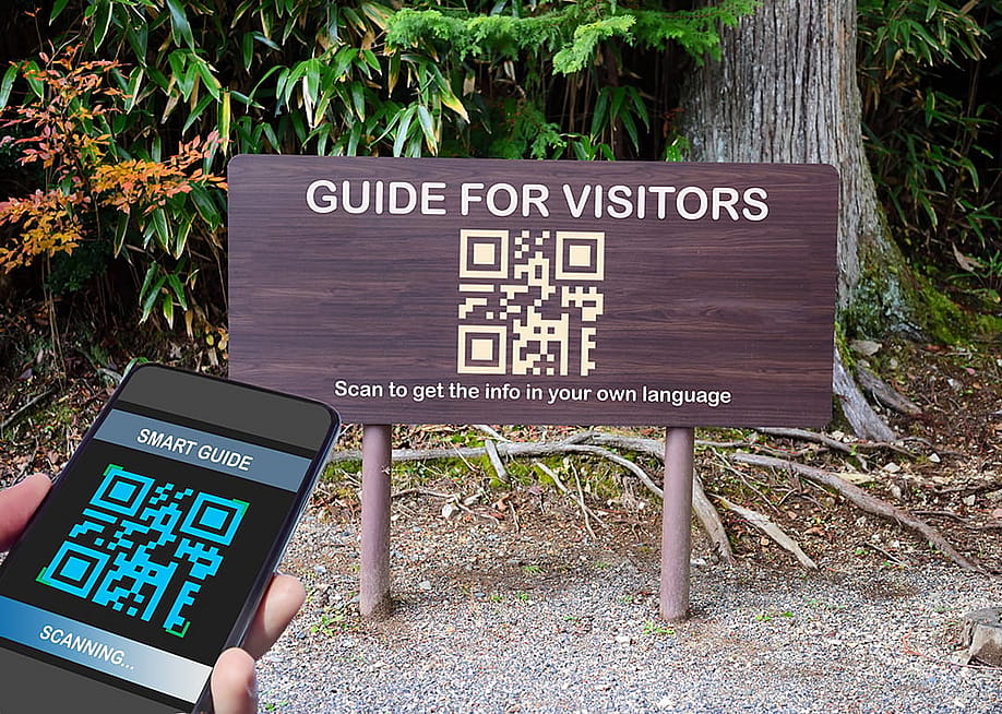 A signage with a guide for visitors QR code label for traveling. — smshoot // Shutterstock