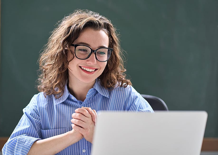 A teacher looking excited while reading good news online. — insta_photos // Shutterstock