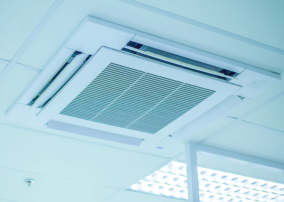 A ceiling air conditioning unit in an office. — Rangsarit Chaiyakun // Shutterstock