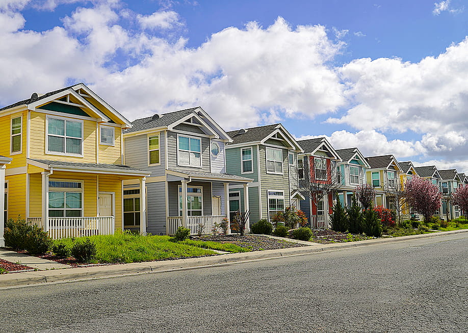 A row of colorful family homes in a residential neighborhood. — JazK2 // Shutterstock
