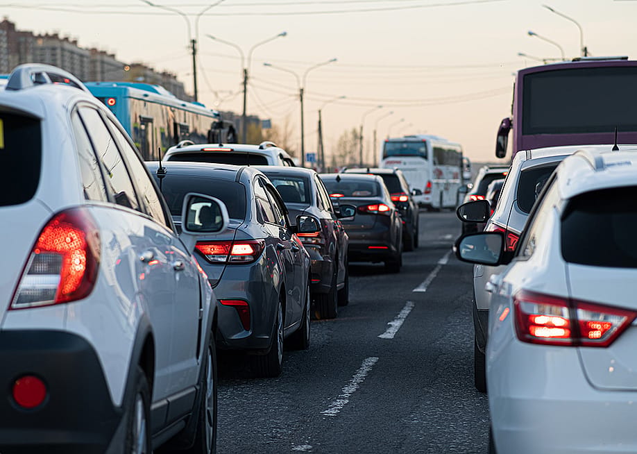 Traffic jamming during rush hour in the city neighborhood at early evening. — Andrey Mihaylov // Shutterstock