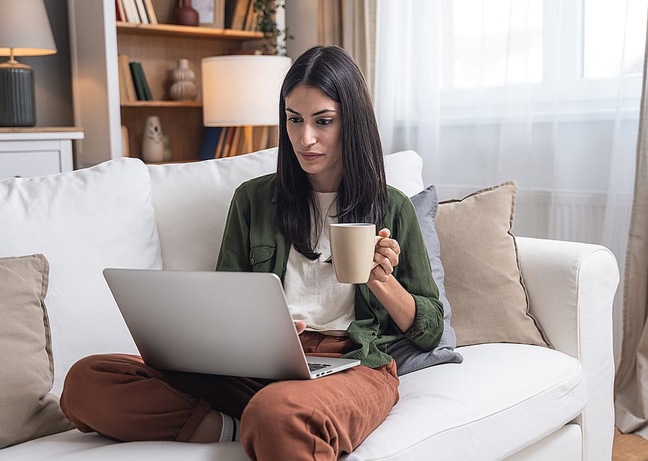 A person checking through her earnings from an online business in a laptop. — Srdjan Randjelovic // Shutterstock
