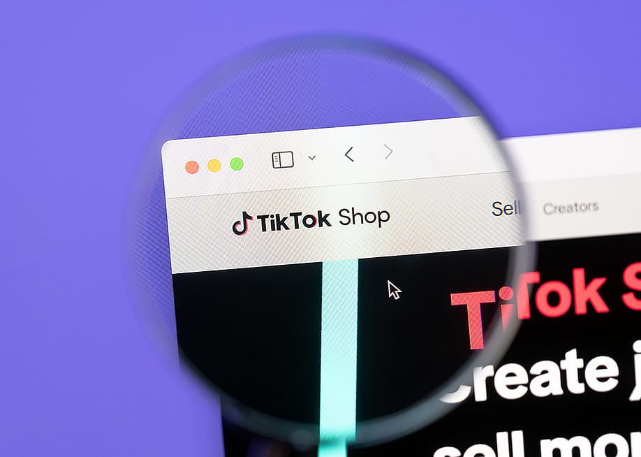A focused shot of Tiktok Shop brand's webpage through magnified lens. — IB Photography // Shutterstock