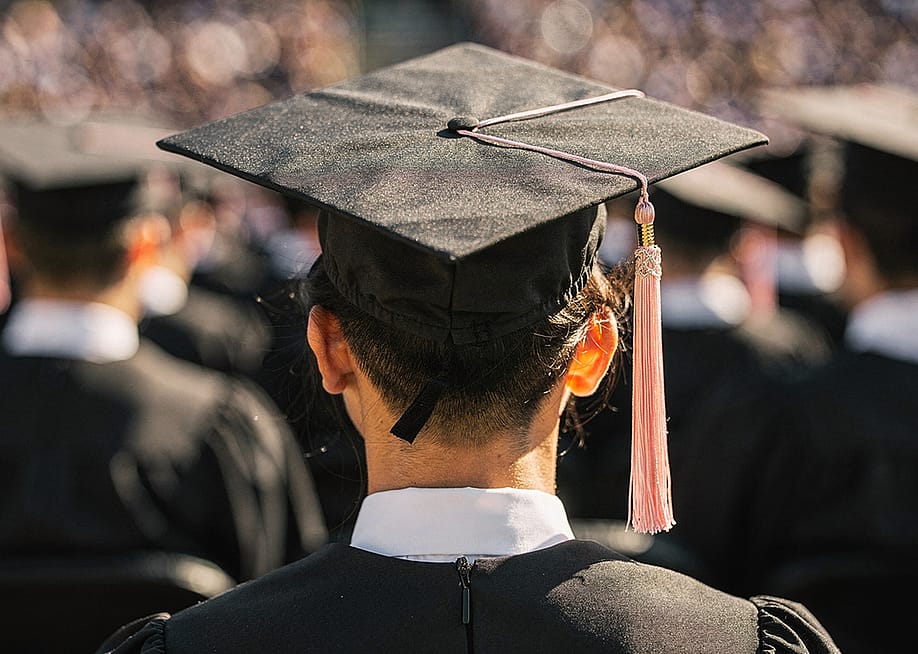 A back view of a university graduate during their ceremony. — Hanz2881 // Shutterstock