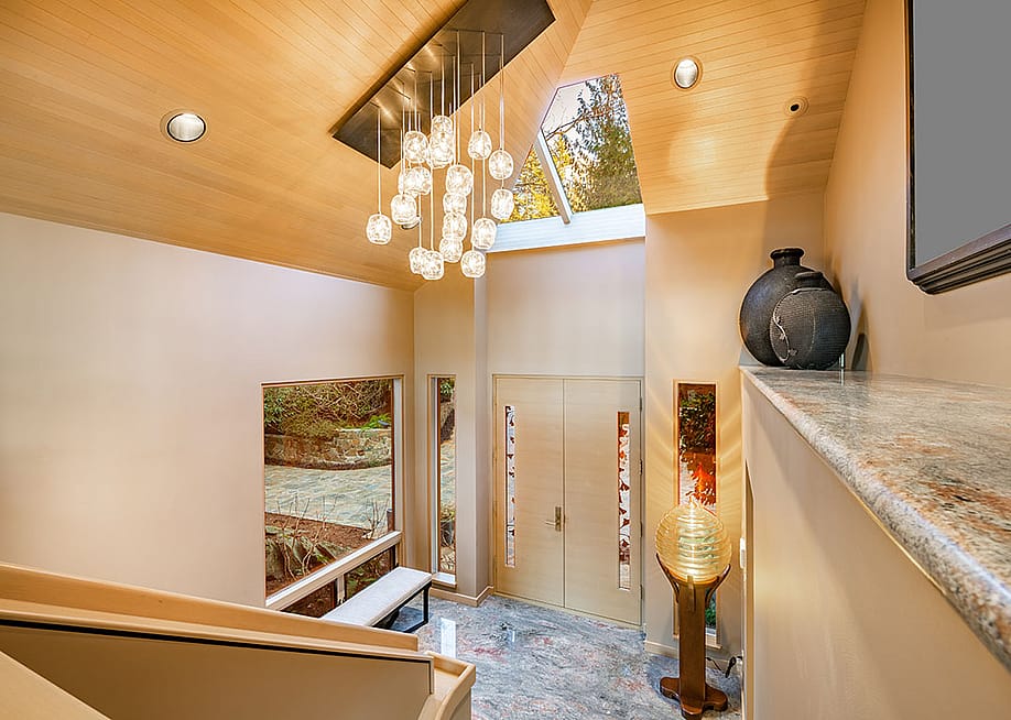 A grand entry foyer of a luxury home with multi-glass ball chandelier. — Sheila Say // Shutterstock