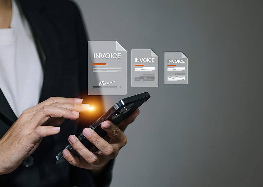 A business manager signing digital invoice documents from her smartphone. — Jutharat Jaroenwong // Shutterstock