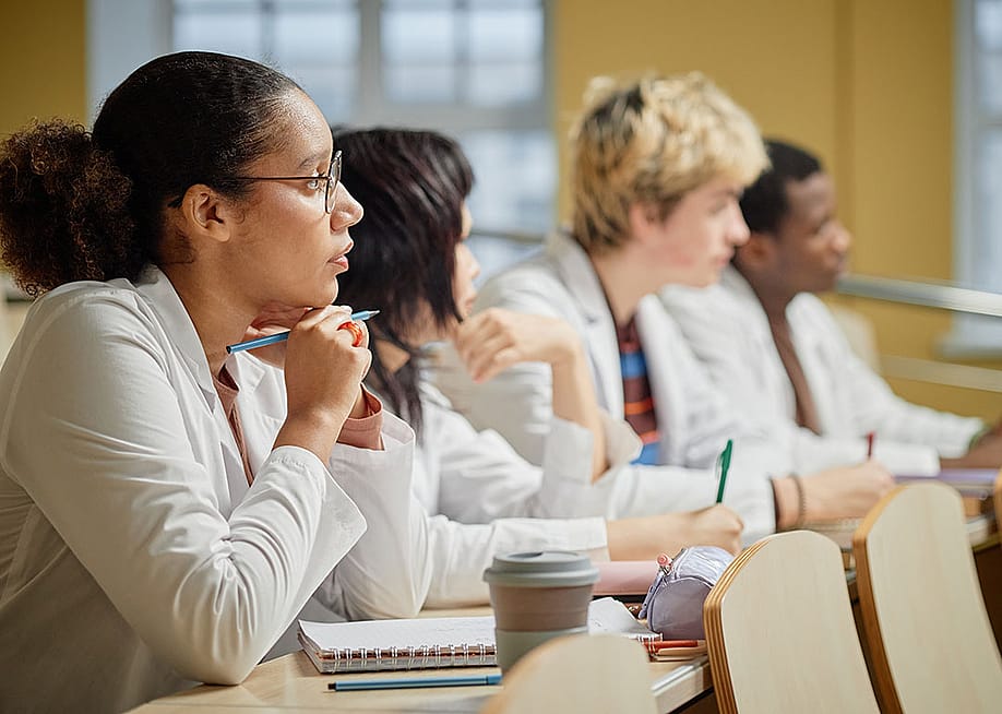 Medical students listening to a lecture at a university. — SeventyFour // Shutterstock