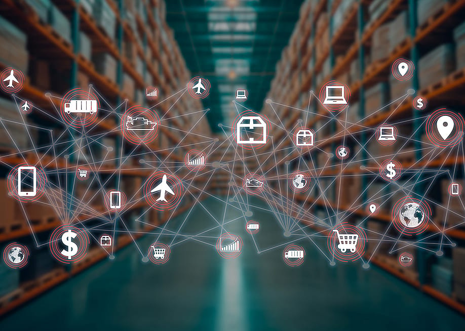 Global distribution concept icons connected together with a product warehouse in the background. — Andrey Piza Stock // Shutterstock