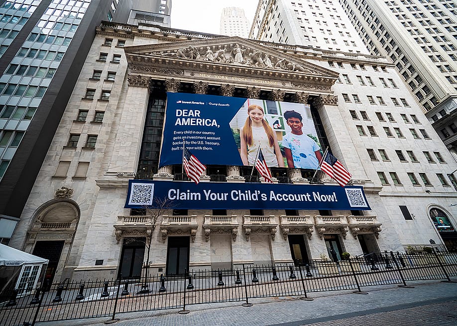 The New York Stock Exchange's facade draped with Invest America | Trump Accounts promotional banners across the building. — rblfmr // Shutterstock