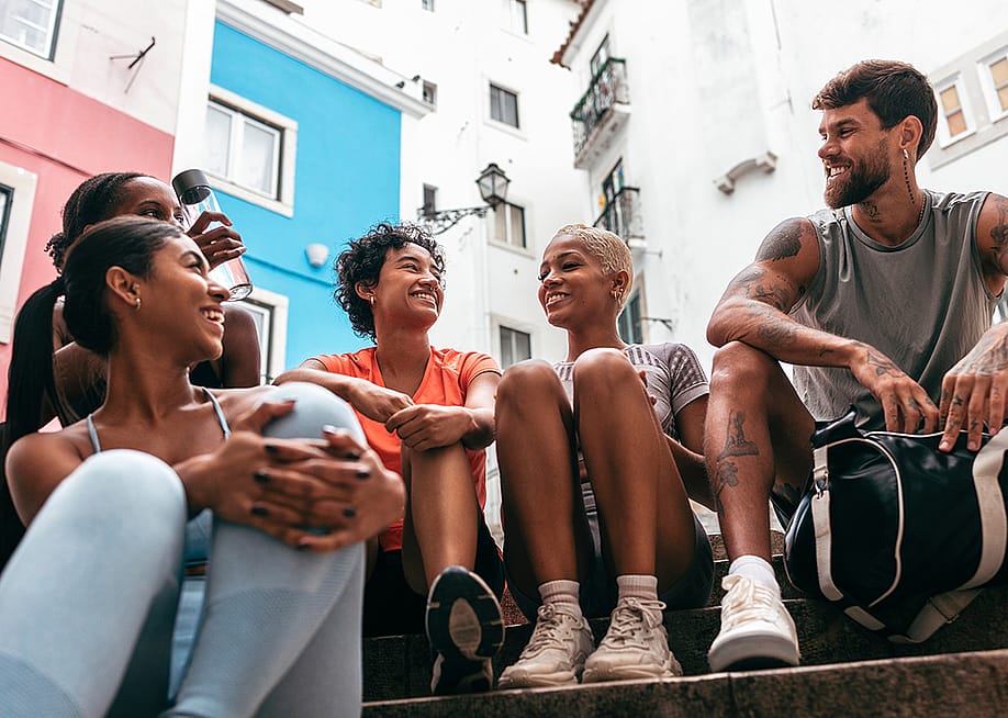 A group of friends having a chat together after a workout. — PintoArt // Shutterstock