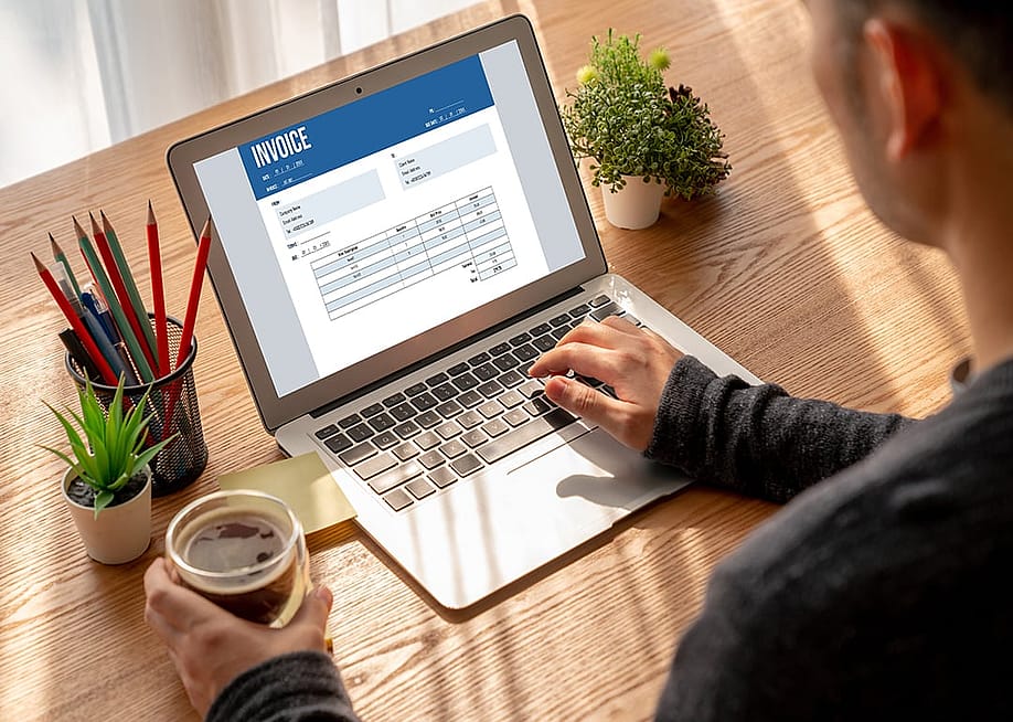 A finance professional working on an invoice. — Summit Art Creations // Shutterstock