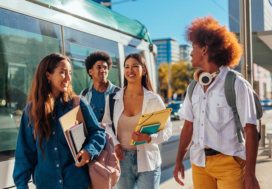 A group of students catching the train to home from school. — bbernard // Shutterstock