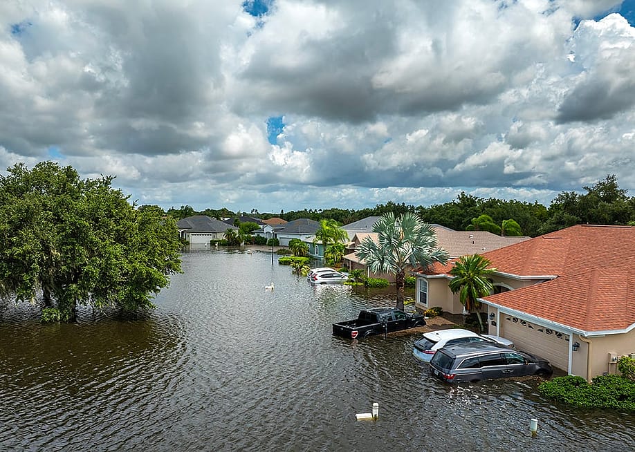 Homes, cars, and roads submerged in floods from a recent typhoon that affected the area. — Bilanol // Shutterstock