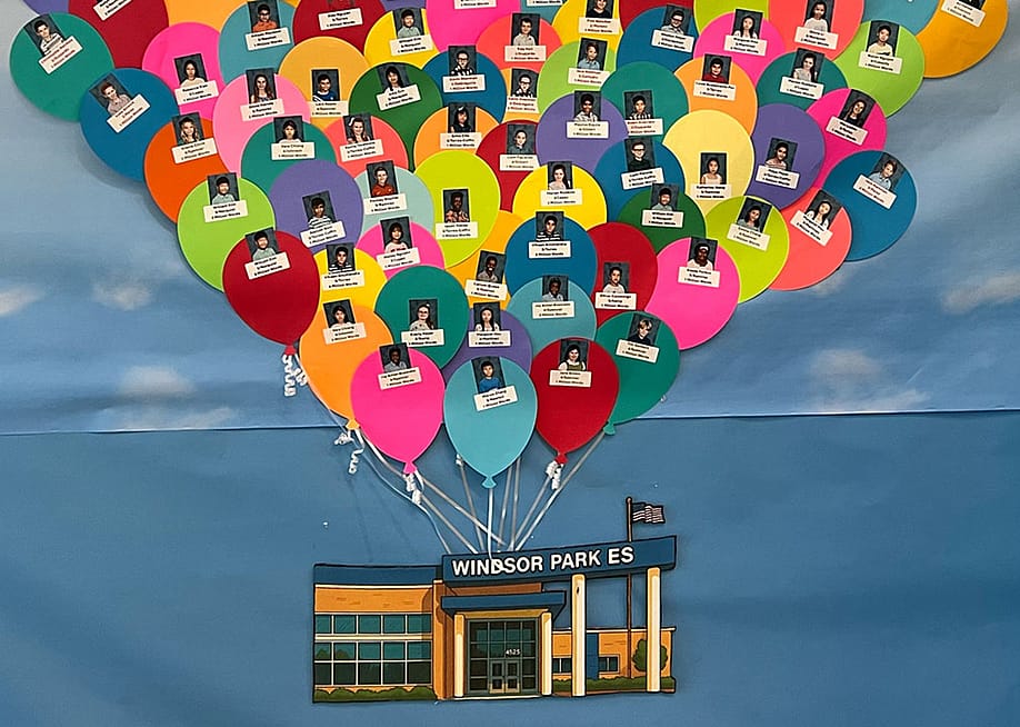 Windsor Park Elementary students are pictured on the school’s Millionaires Club display, which recognizes children who read at least one million words during the school year. — Lauren Wagner for The 74
