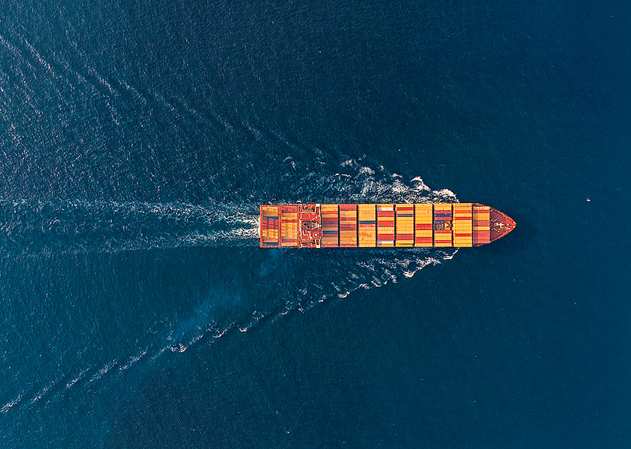 Aerial view of a large cargo ship traveling at sea. — GE_4530 // Shutterstock