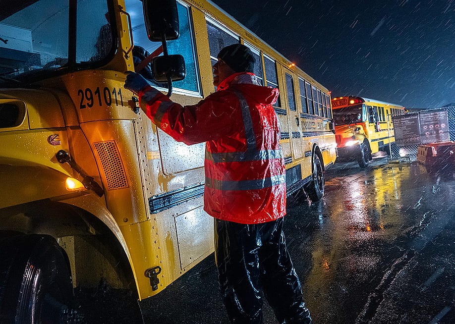 Nearly 2,000 migrants are evacuated by school buses from tents at Floyd Bennett Field to a local high school in preparation for a storm in January 9, 2024. — Spencer Platt // Getty Images