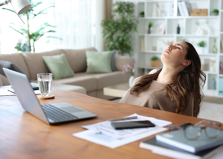 A frustrated employee after being exhausted from working at home. — Antonio Guillem // Shutterstock