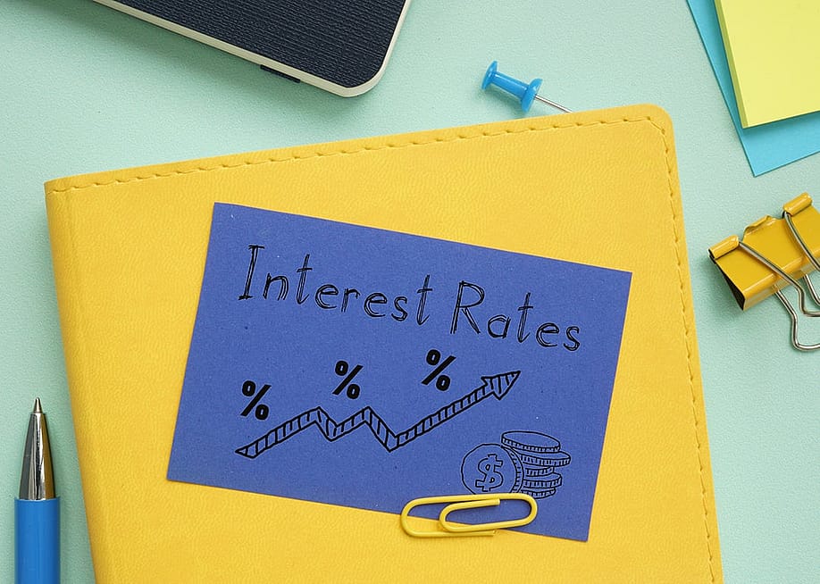 A notebook labeled with interest rates and an illustration. — Jack_the_sparow // Shutterstock