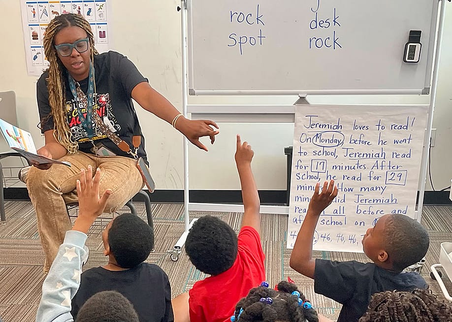 Legacy Prep teacher Maria Coleman led rising second graders in reading a story in Birmingham, Alabama where the charter school is one of more than 450 participating in Bloomberg Philanthropies Summer Boost program. — Linda Jacobson // The 74