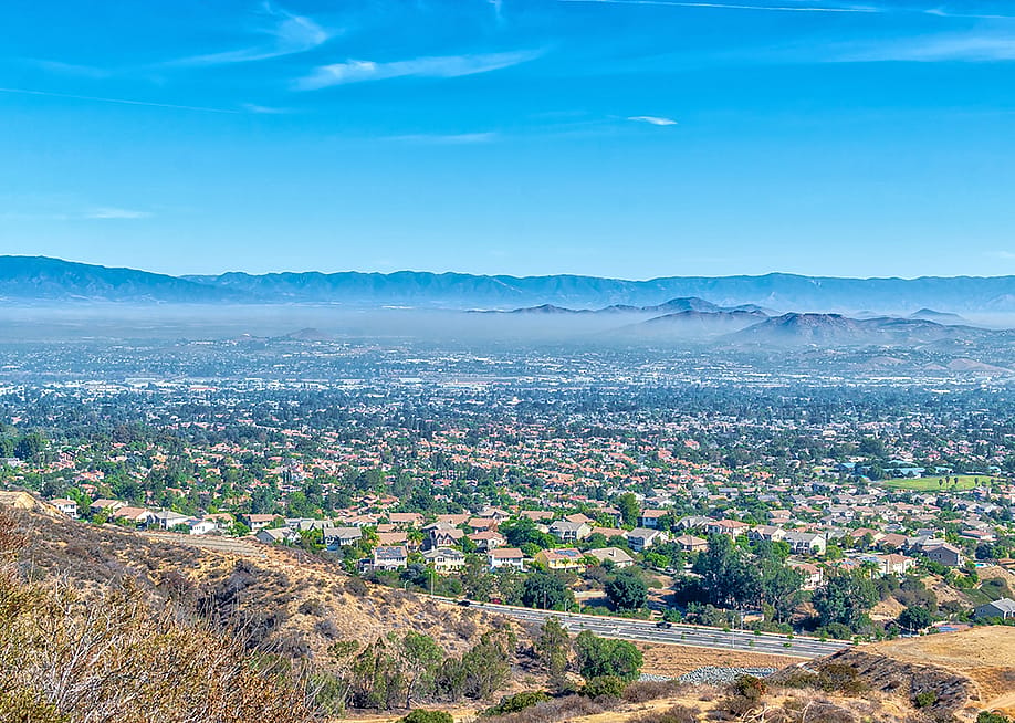 Aerial view of inland California featuring a view of residential homes and hills. — Tim Gray // Shutterstock