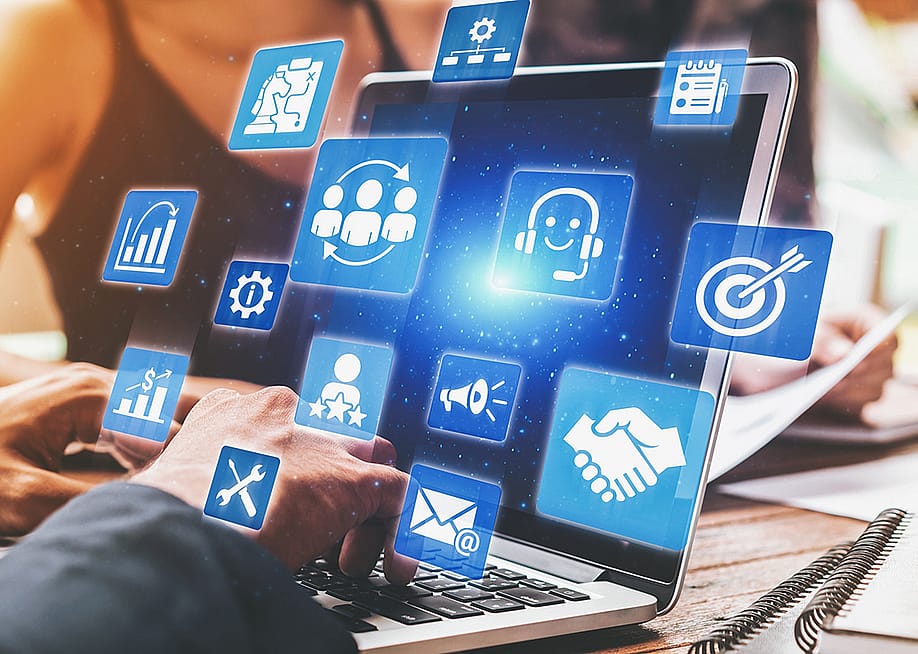 A business analyst managing CRM platforms from a laptop to improve customer relationships through data analysis. — Summit Art Creations // Shutterstock