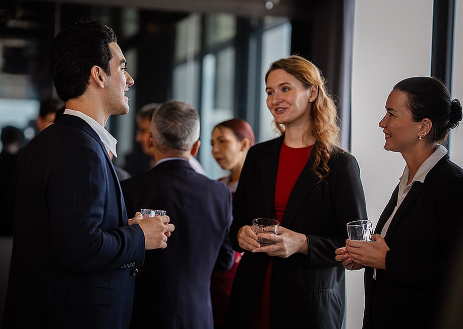 Colleagues engaged in a discussion during a party at work. — Wanwajee Weeraphukdee // Shutterstock