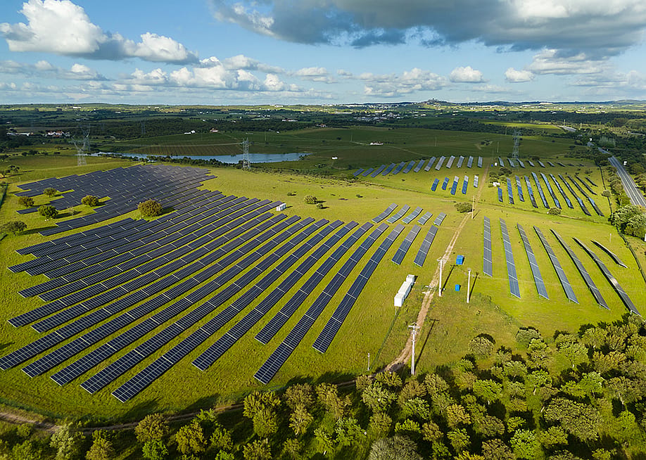 Aerial view of a field with photovoltaic solar panels. — maxterram // Shutterstock