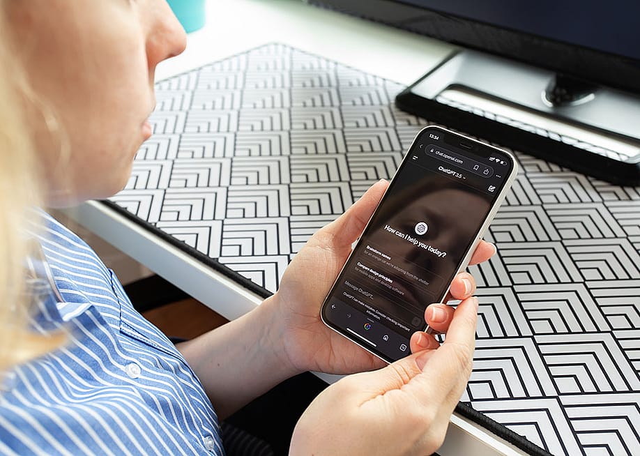 A young adult using a ChatGPT application from a browser in her smartphone. — Yta23 // Shutterstock