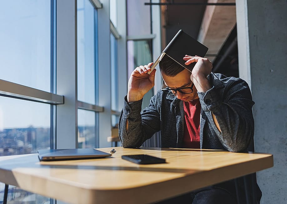 A stressed out businessman during his break in an office. — DS Tkachuk // Shutterstock