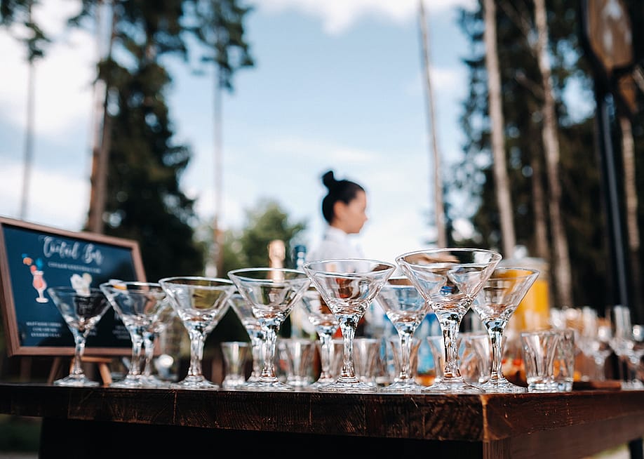 Empty martini glasses on an open bar. — Lobachad // Shutterstock