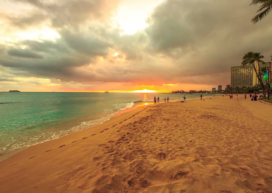 A twilight view seen along the Waikiki beach in Oahu, Hawaii. — Benny Marty // Shutterstock
