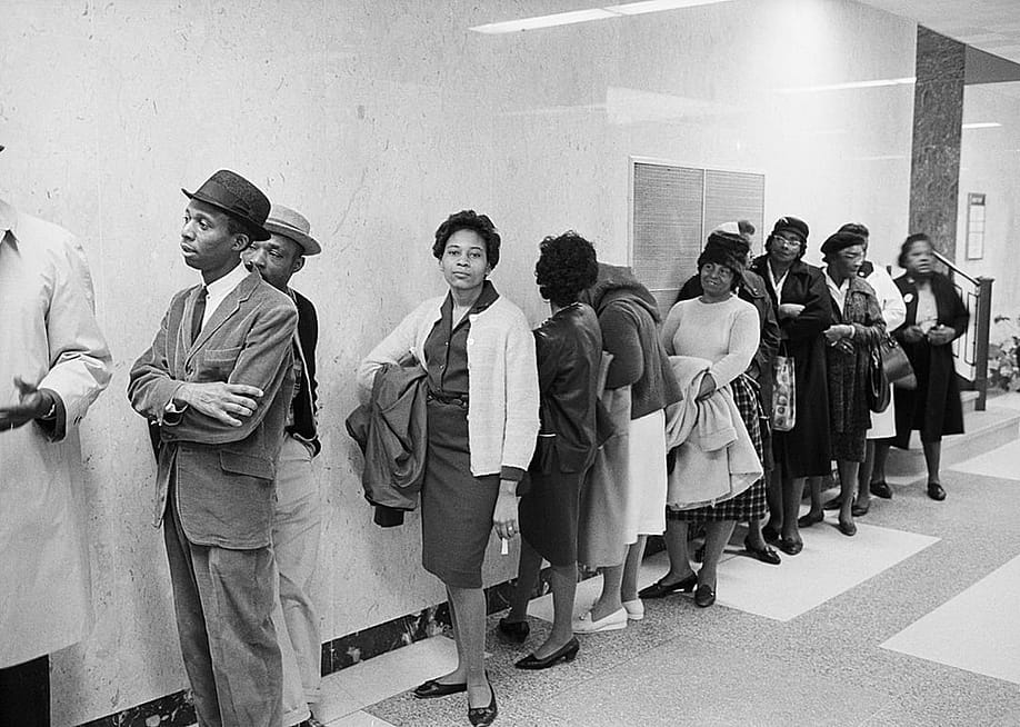 Black American voter applicants wait in line at the Alabama Dallas County Courthouse in January 25, 1965. — Bettman Collection via Getty Images